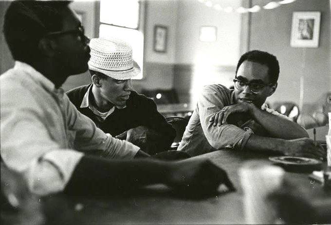 Three men sitting at a lunch counter, in the center is Ivanhoe Donaldson, to the right of him is presumably Julian Bond.
